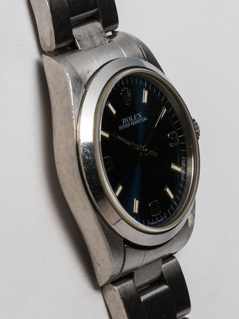 Rolex stainless midsize Oyster Perpetual wristwatch, Ref. 67480, serial number U4, circa 1997. 31mm case with smooth bezel and sapphire crystal. Blue 3/6/9 Explorer style dial. Self-winding movement with sweep seconds. With Rolex stainless steel