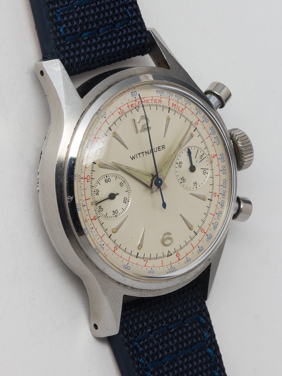 Wittnauer stainless steel two-register manual-wind chronograph wristwatch with round pushers and screw back, circa 1950s. With a very pleasing original matte silvered dial with raised indexes, red telemeter and blue tachometer scale.  Powered by a