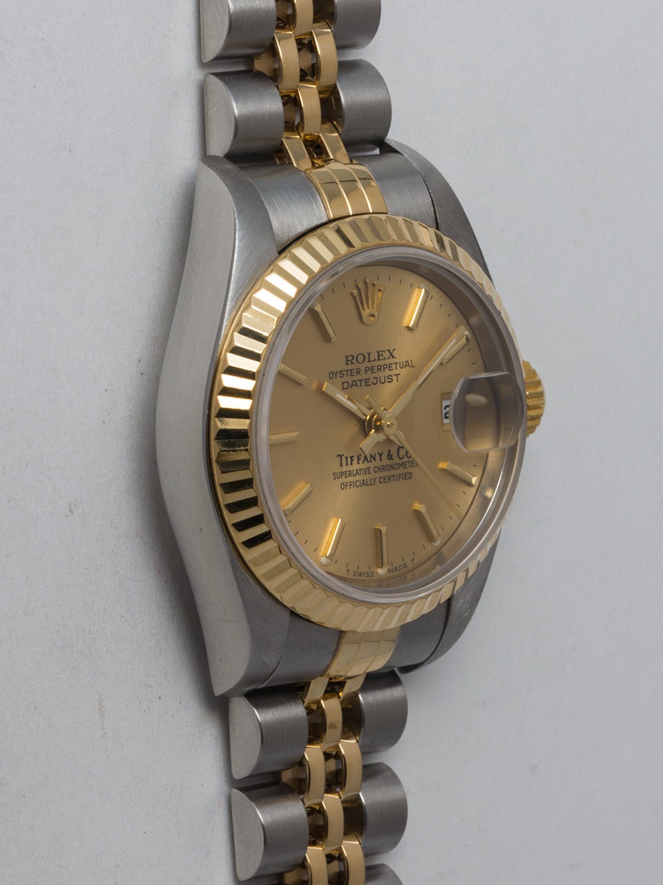 Rolex Lady's Stainless Steel and 18K Yellow Gold Datejust Wristwatch Retailed by Tiffany & Co., Ref. 69173, serial number U2, circa 1997. 27mm diameter case with 18K yellow gold fluted bezel and sapphire crystal. Original signed Tiffany & Co
