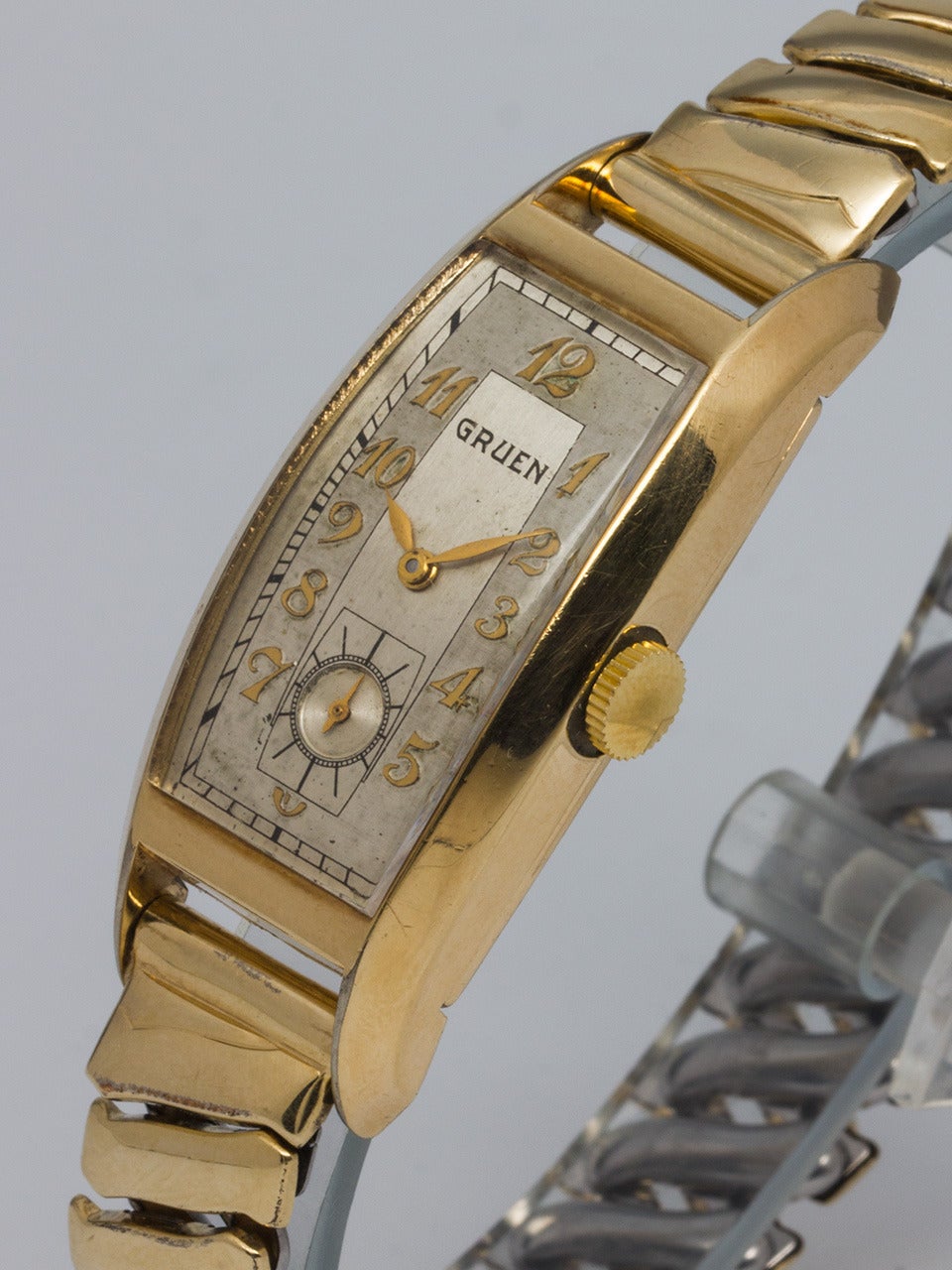 Gruen Yellow Gold-Filled Curvex Wristwatch, circa 1940s, with original two-tone silvered satin dial with raised gold Arabic indexes and gilt leaf hands. Powered by a 17-jewel manual-wind movement with subsidiary seconds. Long and narrow tapered