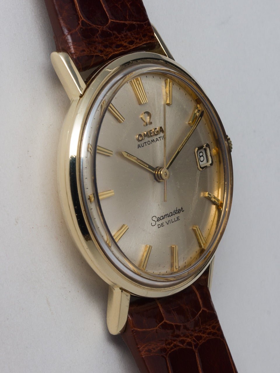 Omega 14K YG Seamaster Deville circa ref # 973.440, movement serial #25 million circa 1967. 34 x 41mm 2 piece case with deeply embossed Seamonster logo on caseback. Featuring beautiful condition original silver satin dial with applied gold indexes,
