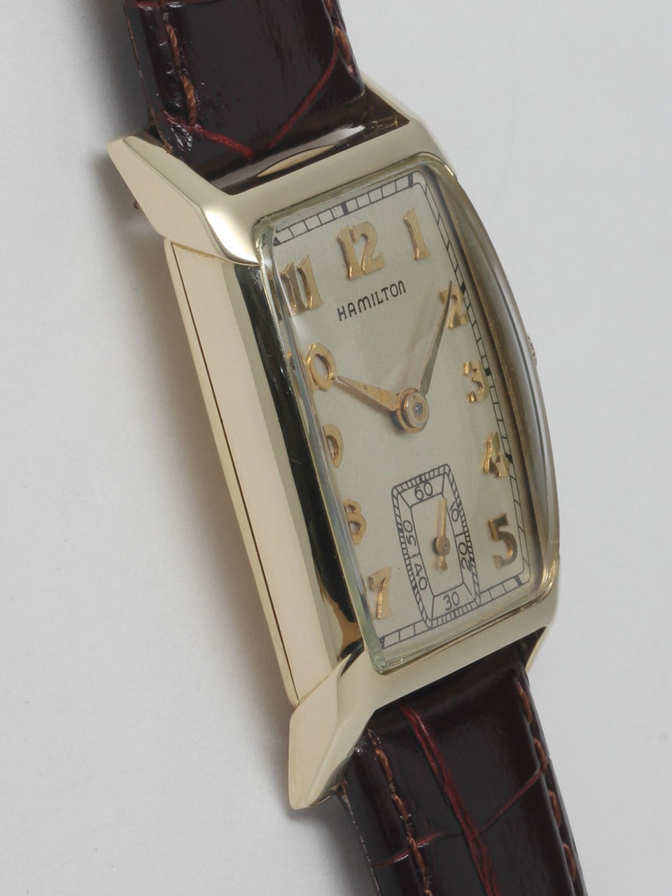 Hamilton 14k yellow gold Donald wristwatch, circa 1940s. 21.5 x 36mm tonneau case with glass crystal. Satin silvered dial with applied gold Arabic numerals and hands. 17-jewel manual-wind movement with subsidiary seconds. Clean, classic model