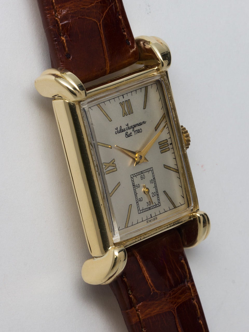 Jules Jurgensen 14k yellow gold rectangular wristwatch, circa 1940s. 23 x 34mm case with large lobed lugs. WIth nicely restored silvered dial with printed Roman and baton numerals, gilt hands. Powered by a 17-jewel manual-wind movement with
