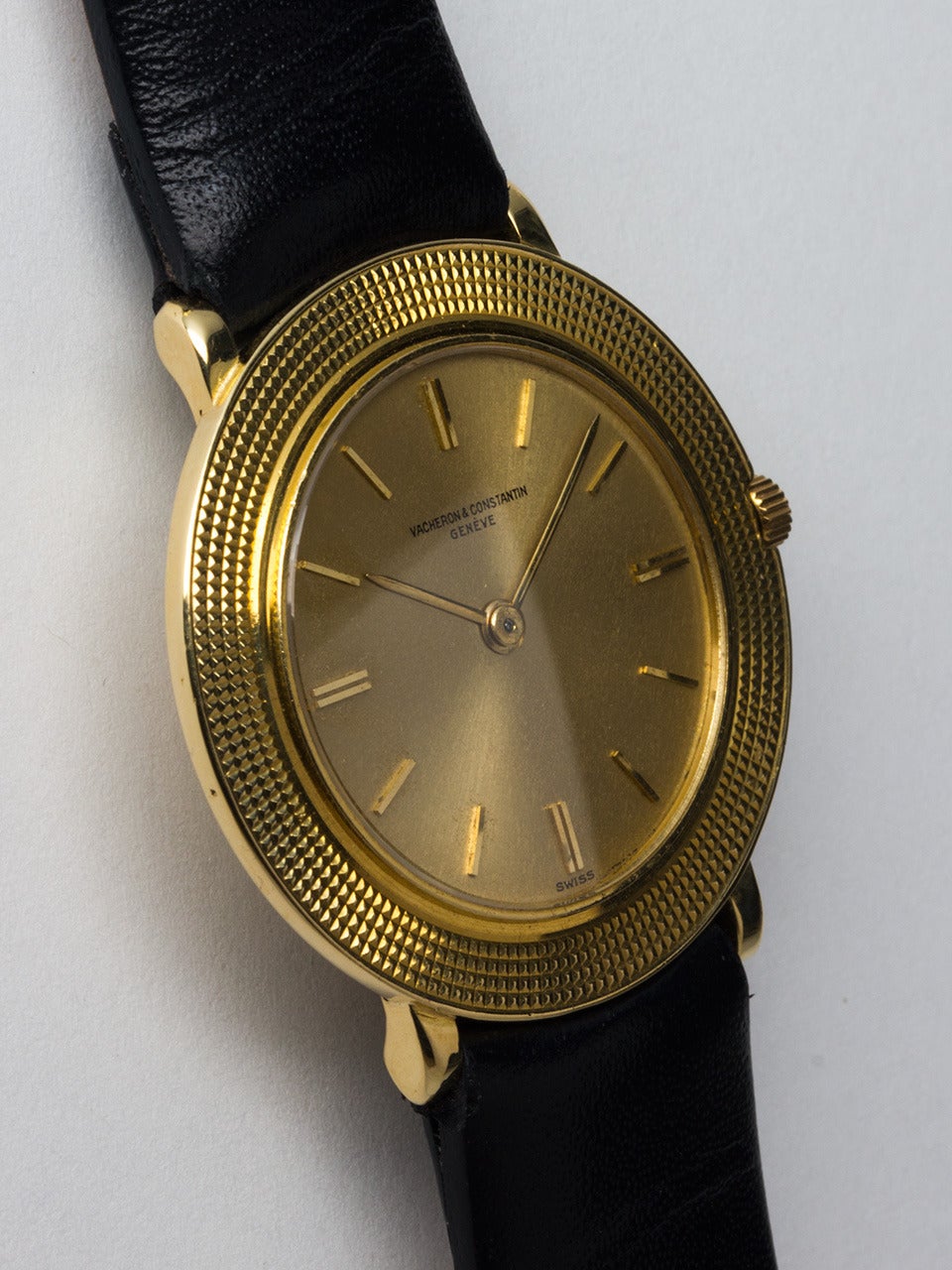Vacheron & Constantin 18K yellow gold dress wristwatch with enlarged textured bezel, Ref. 6395, circa 1960s. 30 x 33.3mm case. With original champagne dial with raised gold markers and simple gold baton hands. Powered by a high-grade 18-jewel