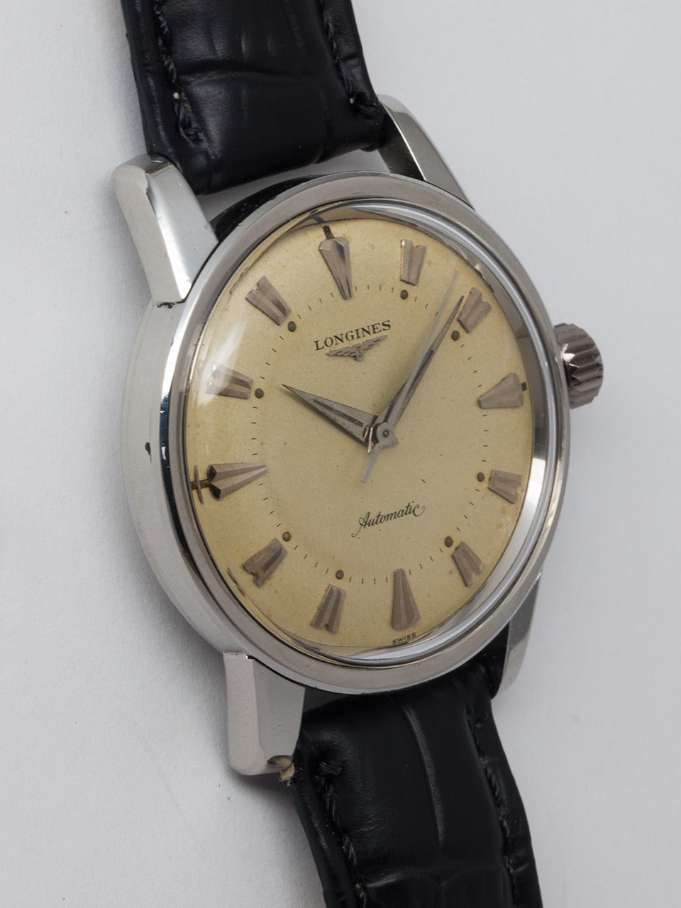 Longines Stainless Steel Automatic Wristwatch, circa 1950s. Large 35mm case with wide bezel, screw back, and heavy extended lugs. Very pleasing original warmly patinaed matte silvered dial with large fluted indexes, inner seconds track with luminous