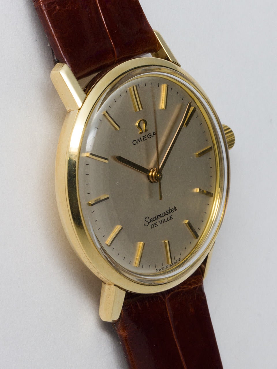 Omega 14K Yellow Gold Seamaster DeVille Wristwatch, Ref. 135.010 circa 1967. 34mm case with deeply embossed seamonster logo on case back, signed Omega crown. Beautiful condition original silvered satin dial with raised yellow gold baton markers and