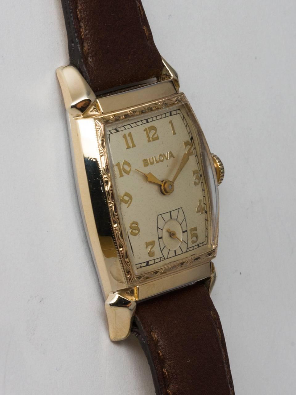Bulova Yellow Gold Filled Dress Model circa 1940s. Small vintage man’s tonneau shaped case measuring 26 x 38mm with engraved bezel and singed Bulova crown. Pleasing original matte silver dial with gold raised indexes and gilt spade hands. Powered by