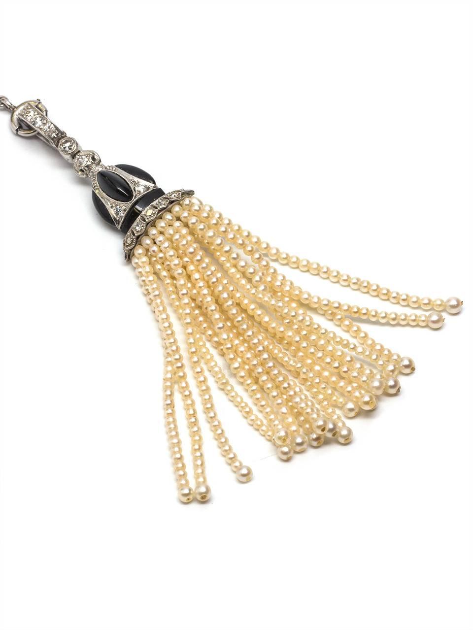 Beautifully crafted platinum chain with delicate stations of rose cut diamonds and little cultured pearls. With a detachable pearl tassle embellished with little bead set diamonds and custom cut black onyx. Stunning design. 15″ before drop. 0.80ct