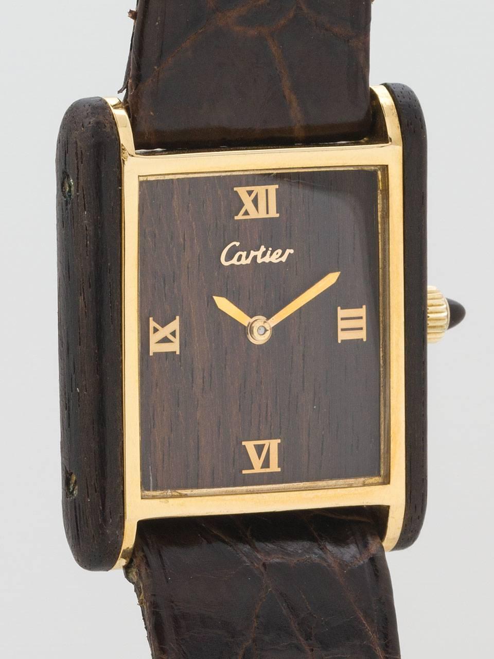Cartier Man’s Vermeil and Wood Case Tank Louis Wristwatch circa 1970s. Unusual model with wood dial and side case panels. Gold plated case with full Cartier signature and numbers on caseback. Featuring a dark wood dial with applied gold Roman