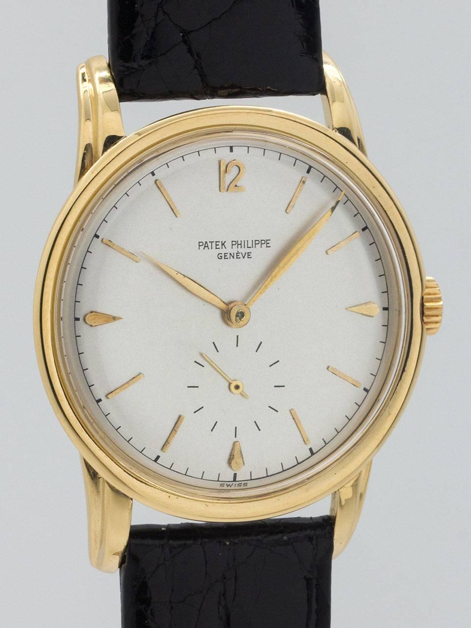Patek Philippe 18K Yellow Gold Dress Model ref no. 2452 circa 1950s. Large size 35 x 44mm snap back case with large fluted lugs, glass crystal and signed Patek crown. Original Patek dial that has been professionally refinished. The beautiful matte