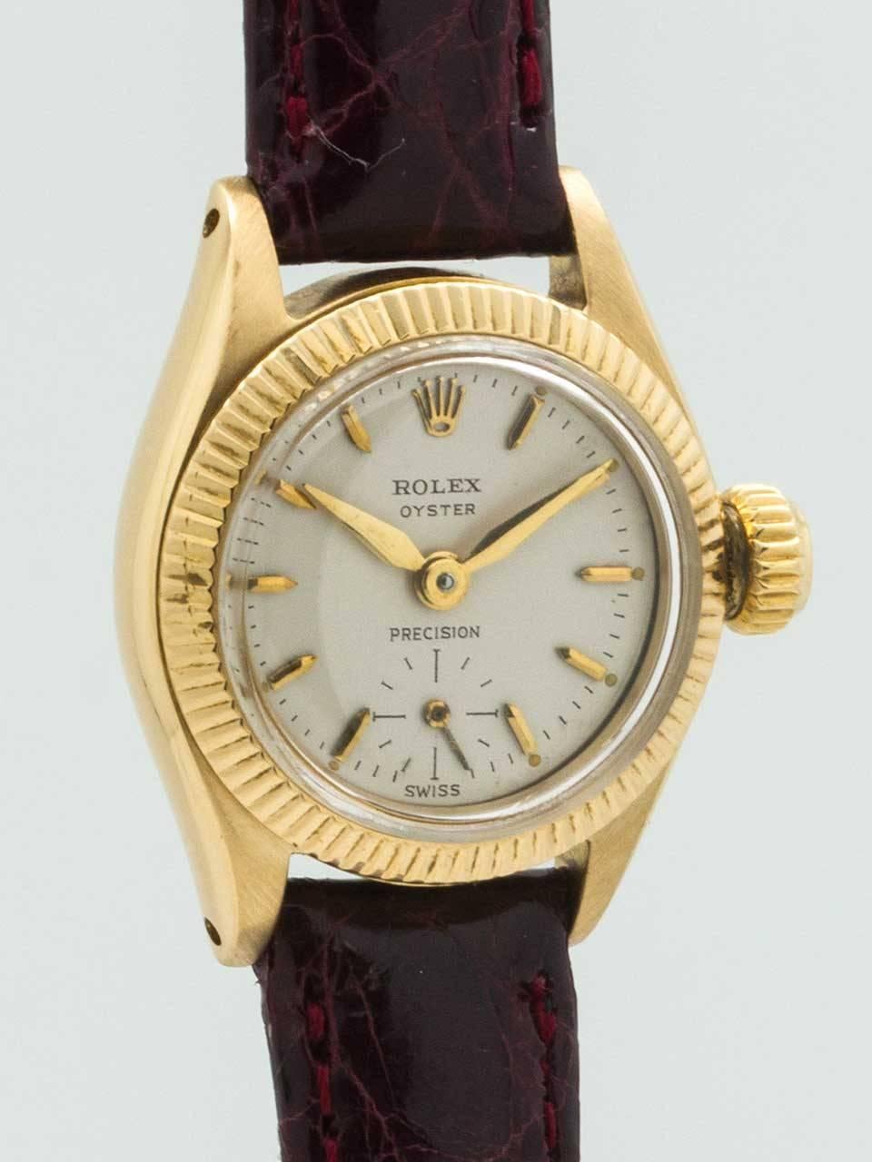 Lady's Rolex 18K Yellow Gold Oyster Precision Wristwatch circa 1958. 27mm diameter Oyster case with fluted bezel, screw down case back and original period crown. With original matte silvered dial with applied gold indexes and tapered gilt hands.