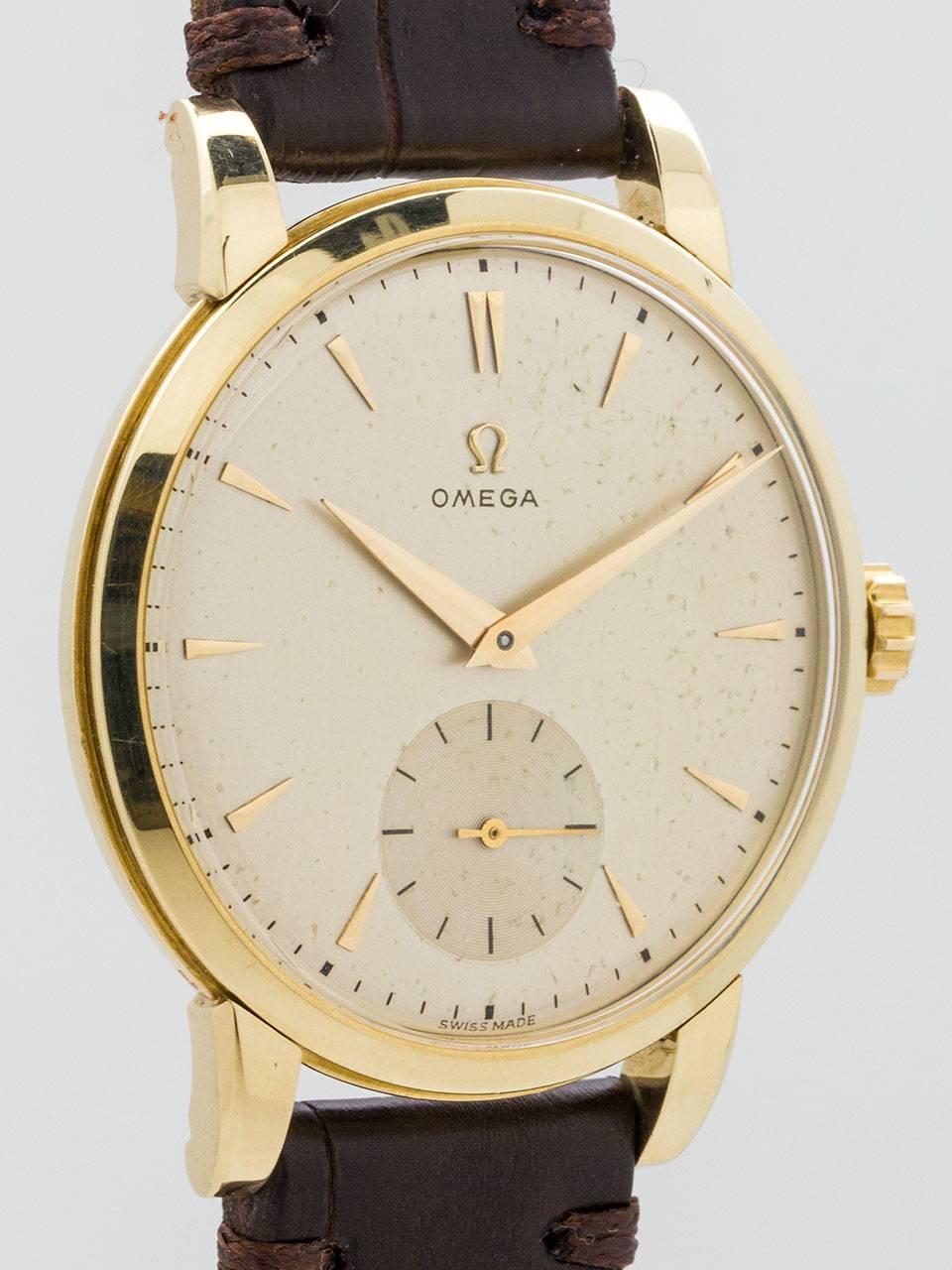 Omega 14K Yellow Gold oversize dress model circa 1950s. 36 x 42mm case with wide sloped bezel and acrylic crystal. Original silvered satin dial with gold applied markers and oversize gilt tapered hands. Powered by calibre 265 manual wind movement