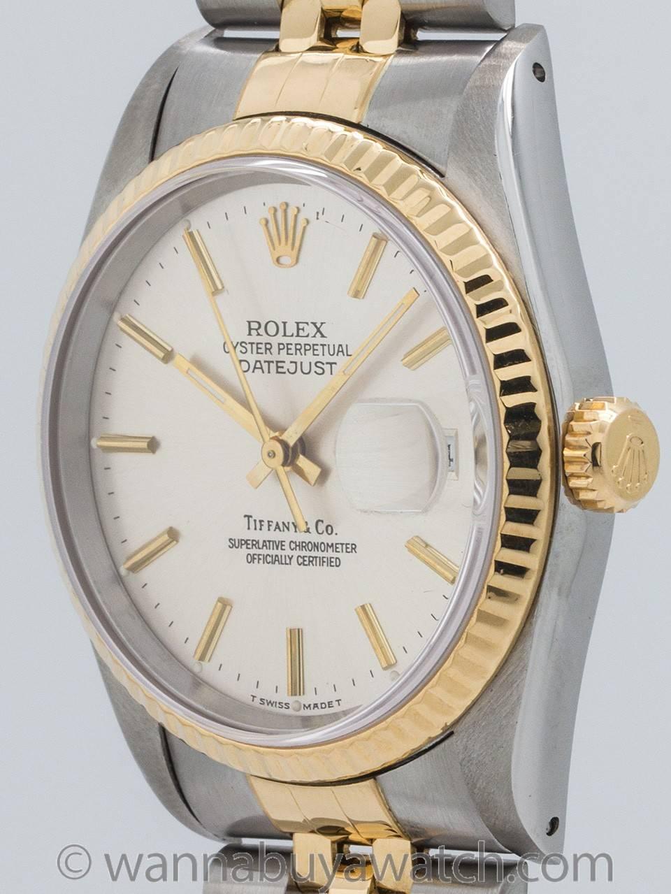 Man’s Rolex Datejust ref 16233 stainless steel and 18K gold serial # E8 circa 1990 retailed by Tiffany & Co. Featuring 36mm diameter case with 18K YG fluted bezel, acrylic crystal, and very pleasing original silvered satin dial signed Tiffany & Co.