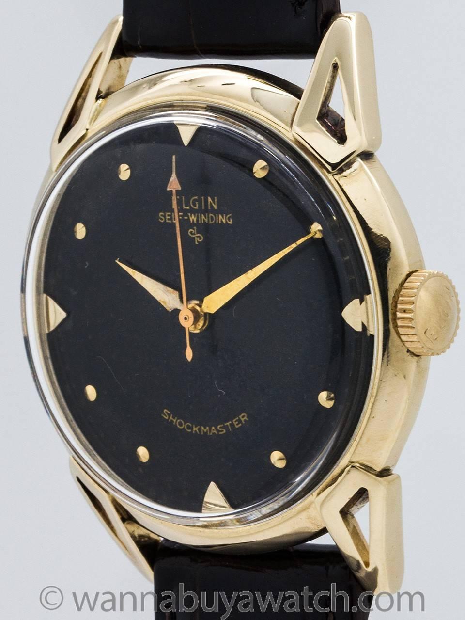 Man’s vintage Elgin 14K gold self winding wristwatch with black original dial circa 1950’s. Featuring 34 x 40mm case with extended horn lugs, acrylic crystal, and very pleasing original black gloss dial with applied gold indexes and tapered gilt