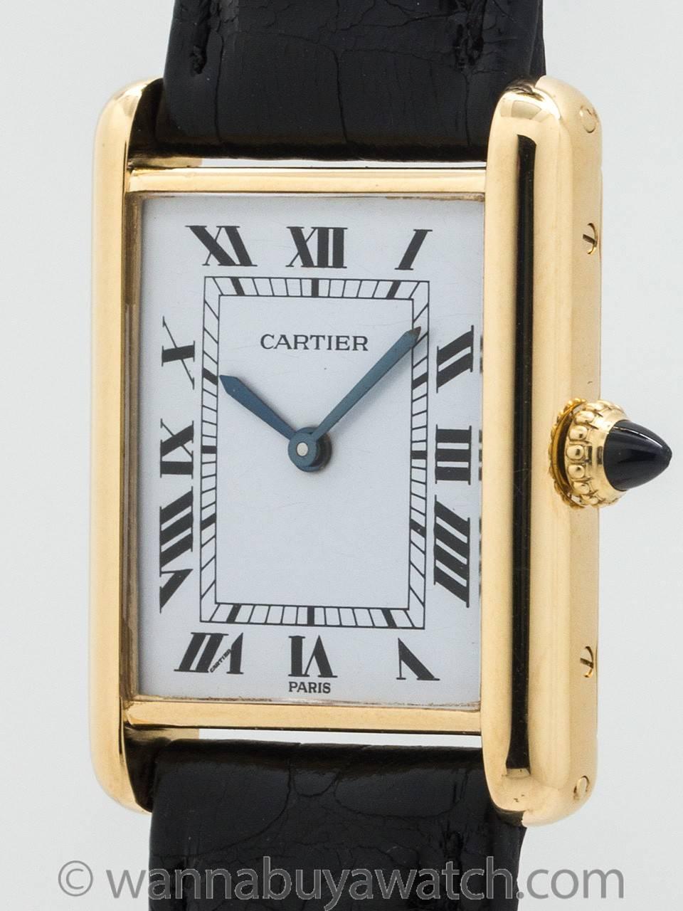 Cartier Man’s 18K Gold Tank Louis circa 1990s. Featuring 23.5 X 30mm rectangular case secured by 4 case screws. Featuring classic white enamel  dial  with printed black Roman numerals and blued steel hands and signed SWISS. Powered by 17 jewel