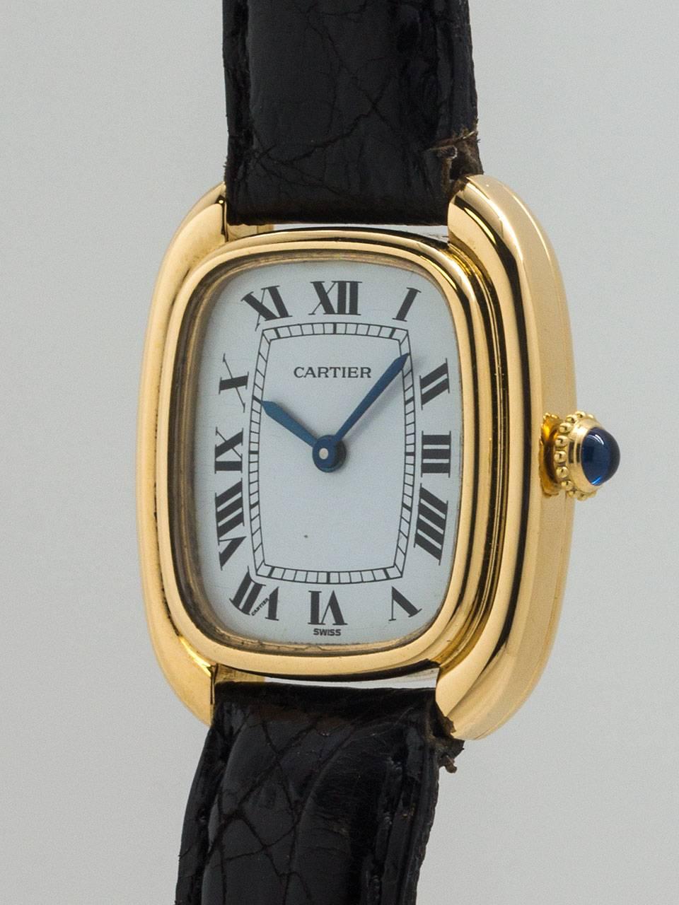 Cartier 18K YG lady Gondole model circa 1970’s. Scarce and great looking elongated cushion shaped case with stepped and grooved sides. With mineral glass crystal and original glossy white classic Cartier dial with Roman figures and blued steel