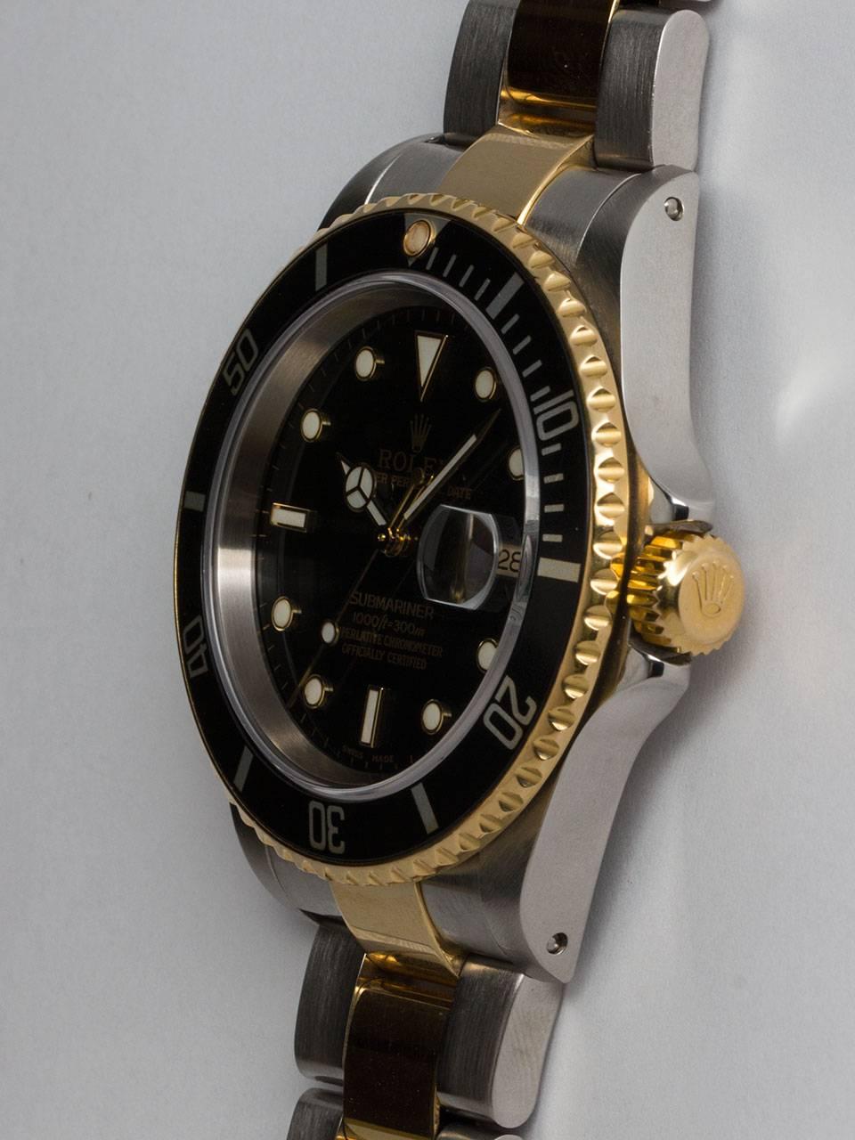 Rolex Submariner stainless steel and 18K gold ref#16613 case serial# D6 circa 2005. Recent, now discontinued model with no holes case, unidirectional elapsed time bezel, sapphire crystal, glossy black original luminova dial with gold luminous