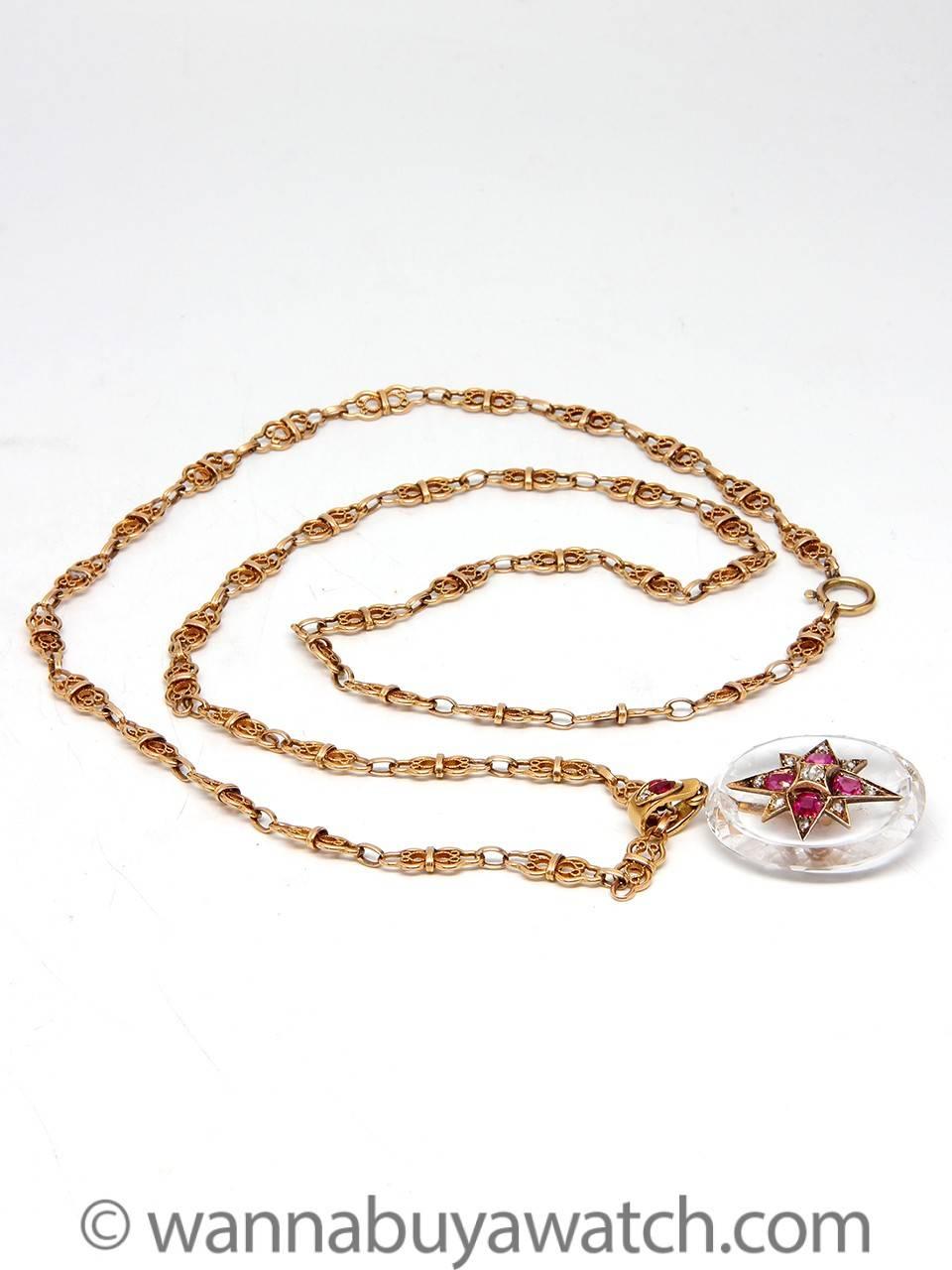 Gorgeous Victorian 18K yellow gold filigree link chain 30″ long with a large oval shaped faceted rock crystal pendant 44 x 25mm stunningly embellished with an 8 point elongated gold star set with 9 rose cut diamonds and 4 brilliant natural rubies.