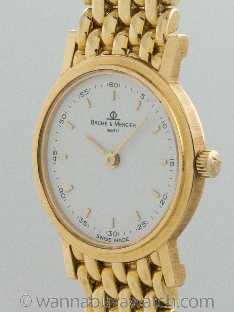 Baume & Mercier women's Gala 18K Yellow Gold Dress Model ref 16746 circa 1990s. 22 x 27mm case with smooth bezel and signed crown. Original white dial with applied gold indexes and hands. Powered by quartz battery. On associated 18K yellow gold rice