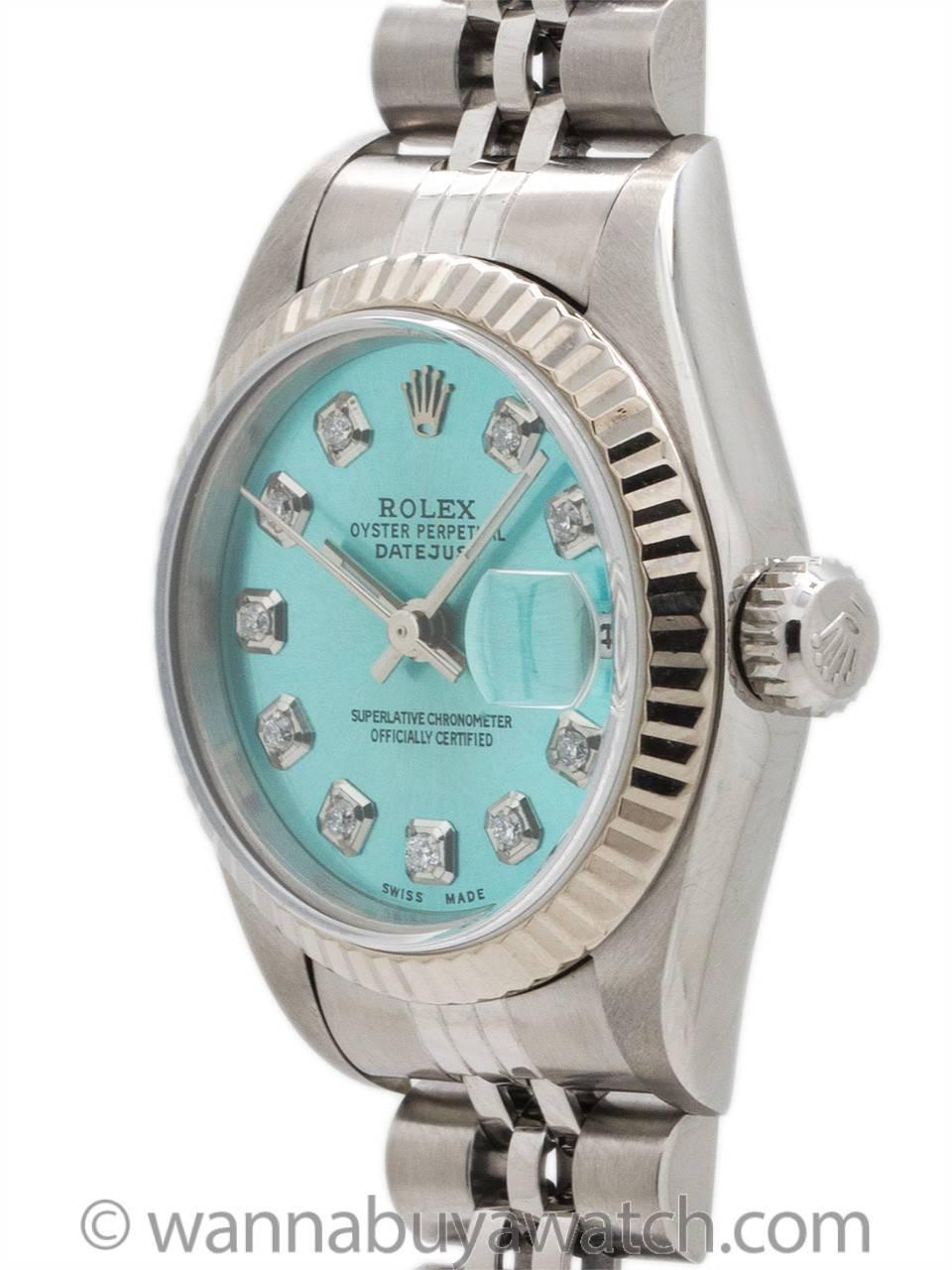 Lady Rolex Stainless Steel Datejust ref 79174 serial# A2 circa 1998. Featuring a 27mm diameter case with white gold fluted bezel, and sapphire crystal. With very popular custom colored “Ice Blue” dial with applied diamond indexes & silver baton