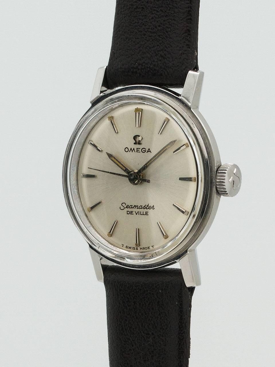 Omega SS lady Seamaster Deville circa 1960’s. Featuring 22mm diameter case, acrylic crystal, original matte silvered dial with stylized raised silver indexes and luminous dots and silver baton luminous hands. Powered by self winding movement with