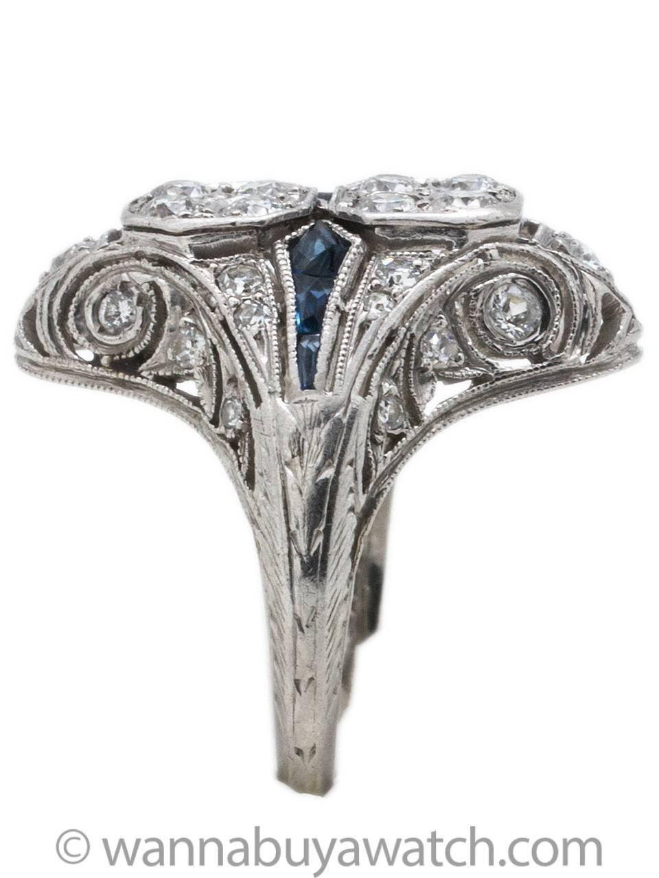 Stunning women’s 1920s Art Deco platinum, diamond and sapphire ring with intricate filigree detailing and craftsmanship.  Eight very bright Old European Cut prong set center diamonds and 22 side diamonds equal total weight of approximately 1.00ct 