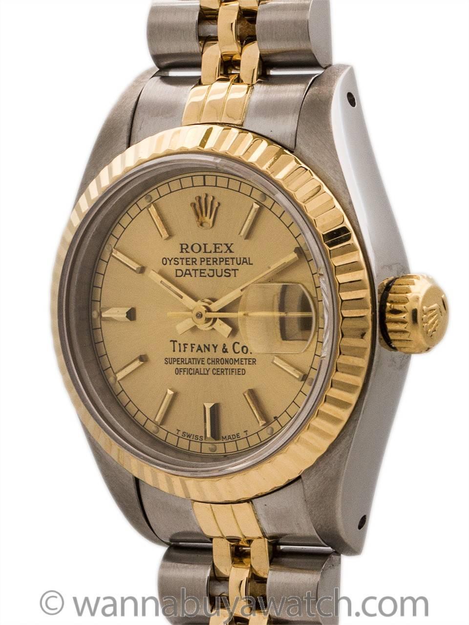 Lady Rolex Datejust ref 69173 SS & 18K YG E serial # circa 1990 retailed by Tiffany & CO. Very desirable double name model featuring 27mm diameter case, 18K YG fluted bezel, sapphire crystal, original champagne dial signed Tiffany & Co,