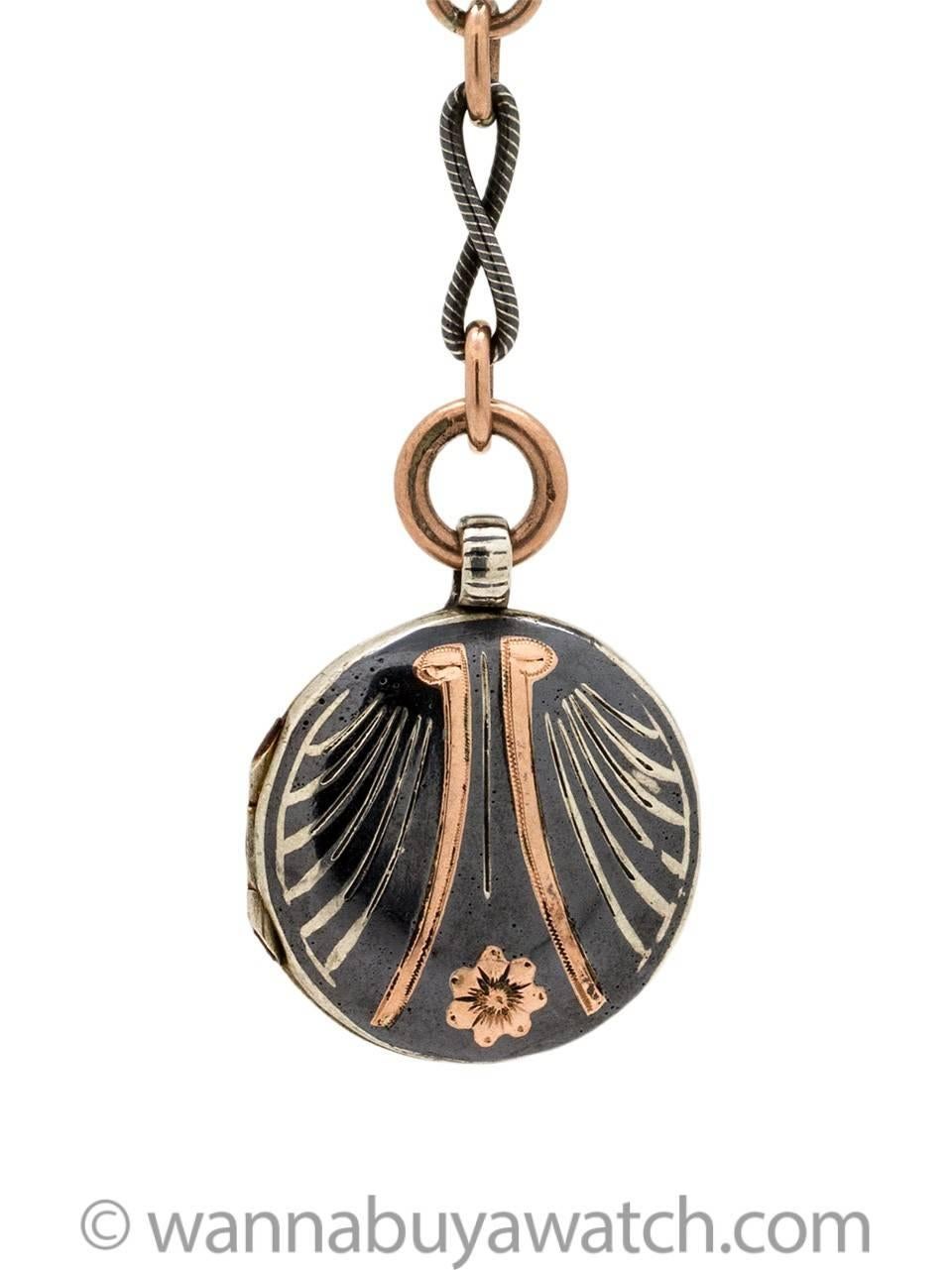 Striking Niello sterling silver and rose gold filled locket on 17 inch chain, with gorgeous contrasting etched, swirled links. Large, etched spring ring bail clasp on detachable locket pendant, which is 3 inches long. The locket itself is adorned