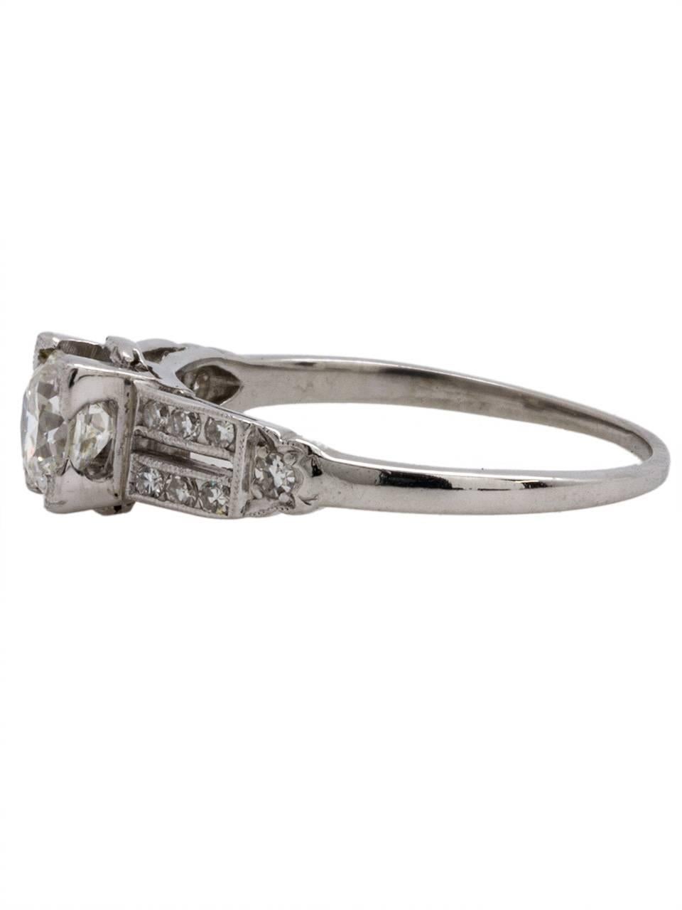 Gorgeous Art Deco 1930s platinum diamond engagement ring, set with very bright and lively EGL certified .68ct round transitional cut center diamond rated G color (near colorless),exceptional VS1 clarity. Two rows of bead set side diamonds with