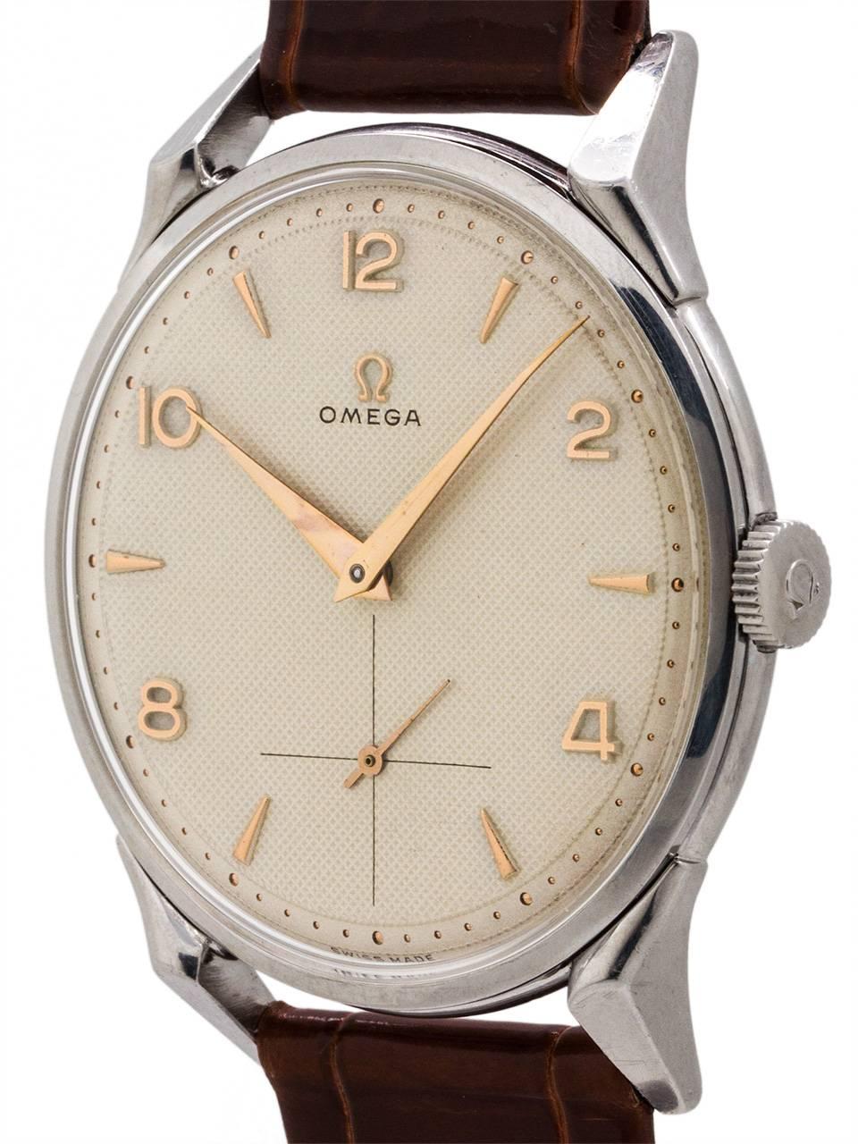Vintage Omega stainless steel manual wind dress model ref 2603.12 with movement serial # 14.2 million circa 1954. Featuring large 37 x 45mm case with substantial grass hopper lugs, heavy snap back case, acrylic crystal, and very pleasing original