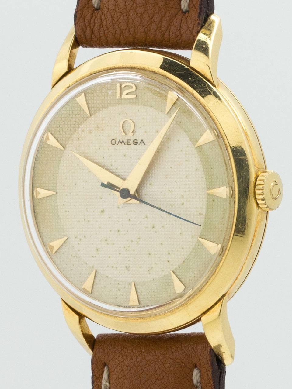 Omega 18K Yellow Gold circa 1950s. Large for the era, 34 x 43mm heavy snap back case with acrylic crystal and beautiful original 2 tone textured dial with raised triangular indexes and tapered sword style hands. Powered by 17 jewel manual wind