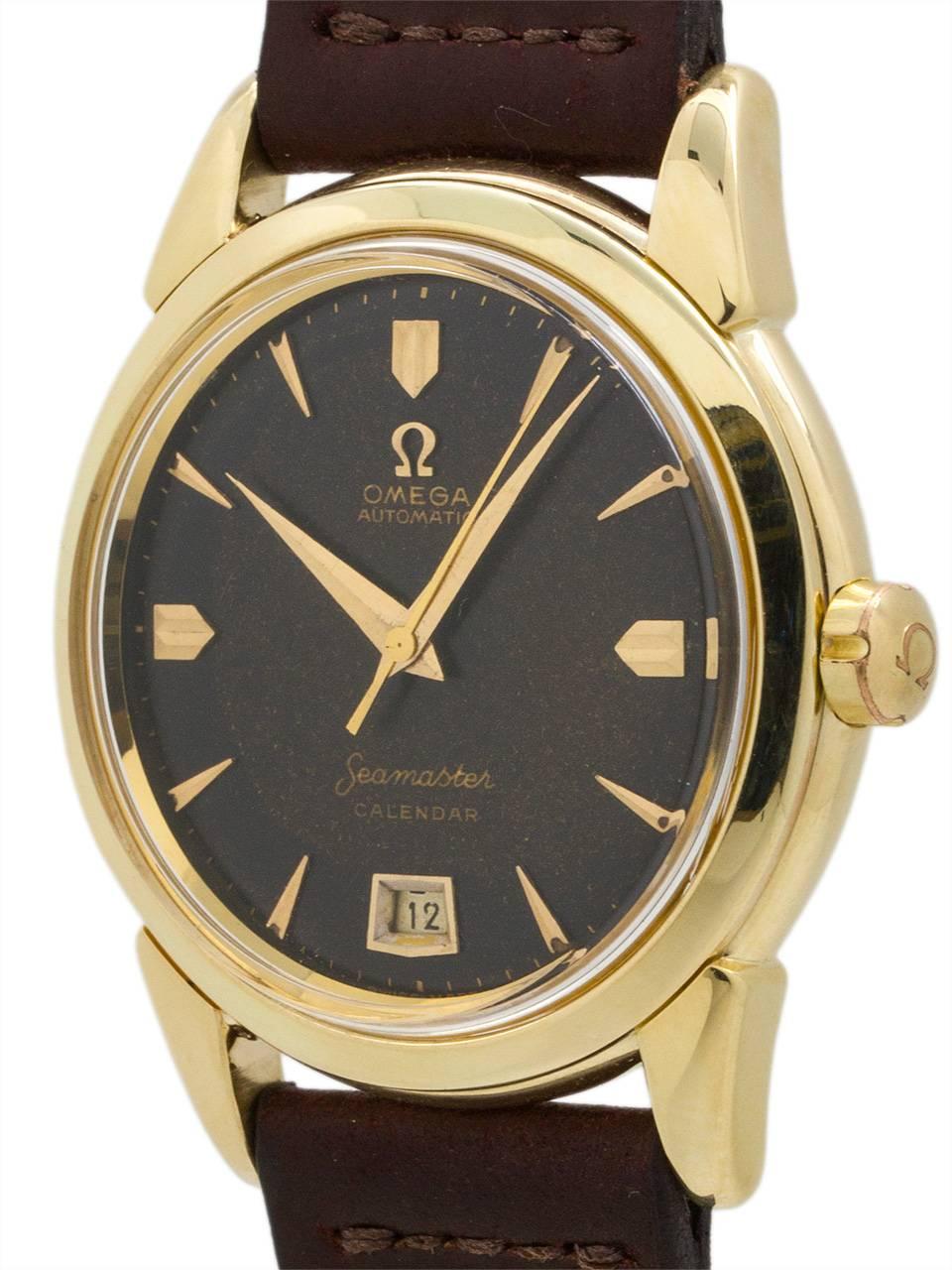 Omega 14K yellow gold automatic Seamaster Calendar with heavy screw back case and large contoured lugs. With great looking original patina’d black dial turning chocolate. With gold applied faceted indexes and large tapered sword hands. Powered by
