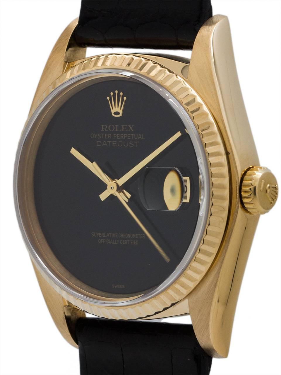 A beautiful condition scarce Rolex 18K gold Datejust ref# 16018 circa 1981 with factory Onyx dial.  Featuring a 36mm diameter case with fluted bezel and sapphire crystal. With stunning factory black onyx dial with applied gold Rolex logo and gilt