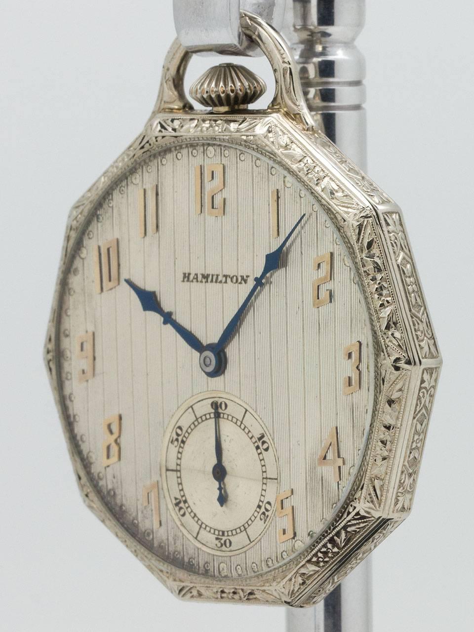 Hamilton 14K white gold open face dress pocket watch circa 1929. Featuring a man’s 12 size 45mm diameter 10 sided case with deeply engraved detailing. Original matte silver dial with pin stripe, tapestry pattern and with gold applied art deco style