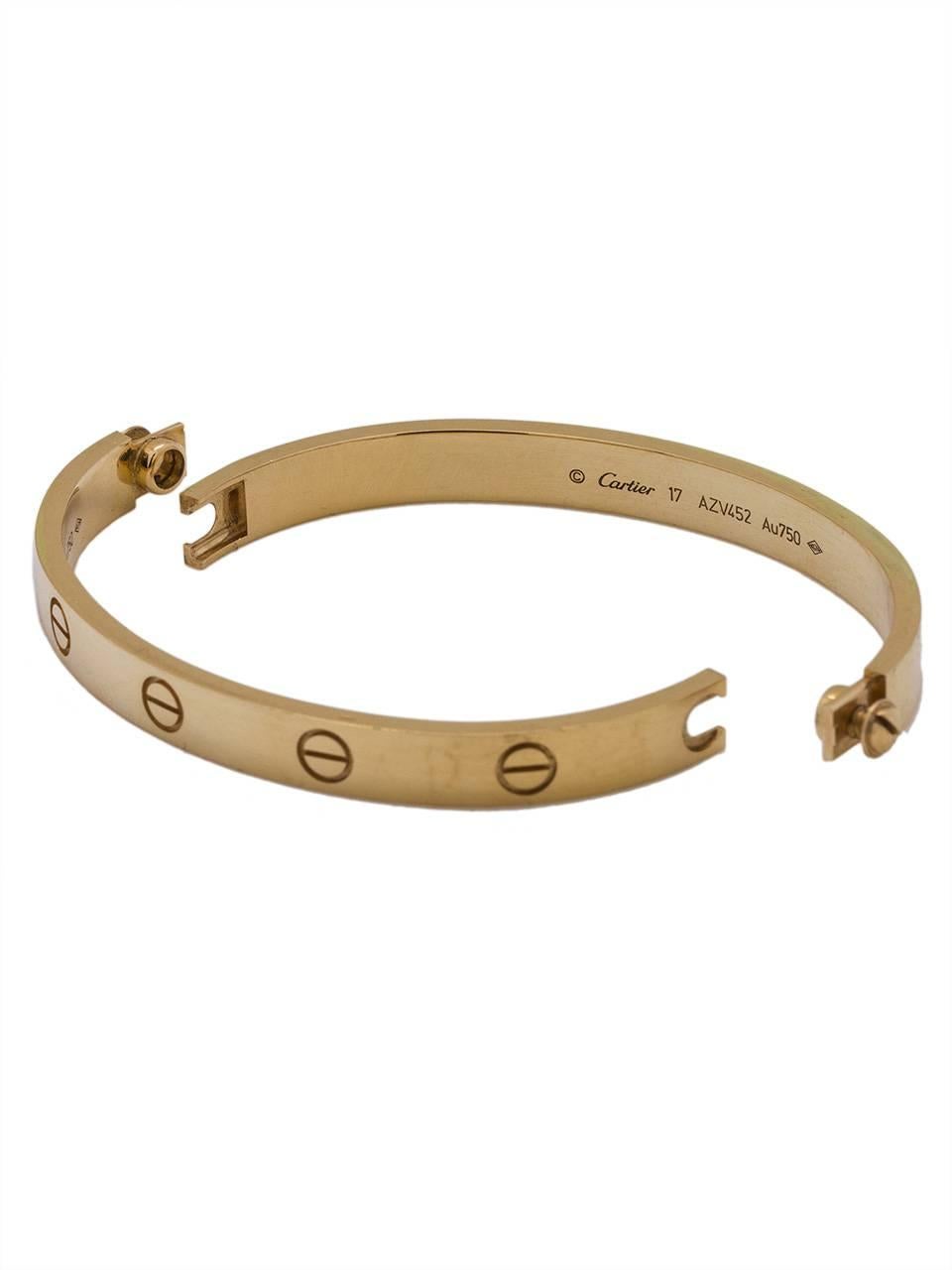 Cartier 18K YG “Love Bracelet” size 17 in mint pre-owned condition, newer style complete with original Cartier box, certificate and screwdriver. New style that screws do not remove all the way so will not get lost. Size 17 is one of the most popular