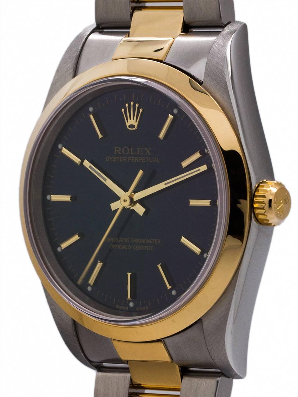 Rolex Man’s  SS/18K YG Oyster Perpetual ref# 14203 serial# D5 circa 2003. Featuring a 34mm case with smooth bezel, sapphire crystal, and  with original glossy blue dial with applied gold indexes and gilt baton hands. Featuring a man’s size 34mm