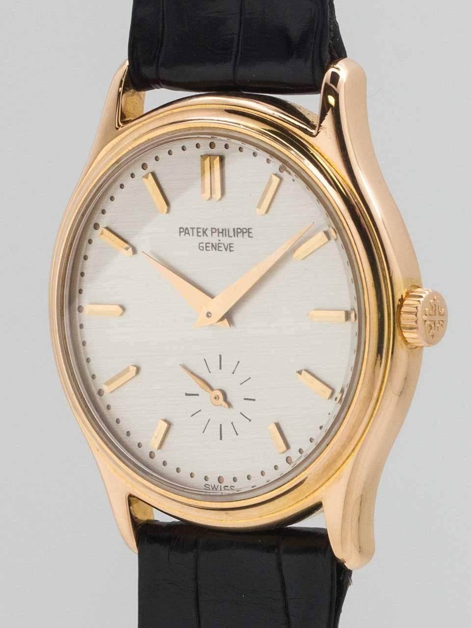 
Patek Philippe 18K Pink Gold dress model ref # 3923 circa 1990’s. 32 X 38mm snap back case with original silvered satin dial with applied pink gold indexes and tapered rose gold sword hands. Powered by 18 jewel manual wind movement with subsidiary