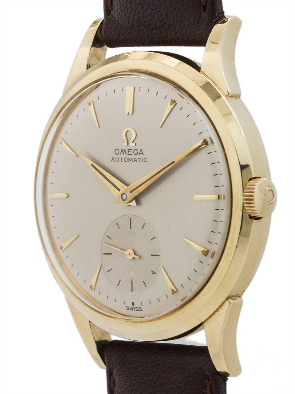 Omega gold shell top and stainless steel screw down caseback, self winding wristwatch circa 1954. Featuring 35 x 42mm screw back case with large tear drop lugs, dome bezel, acrylic crystal, and original 2 tone silvered satin dial with applied baton