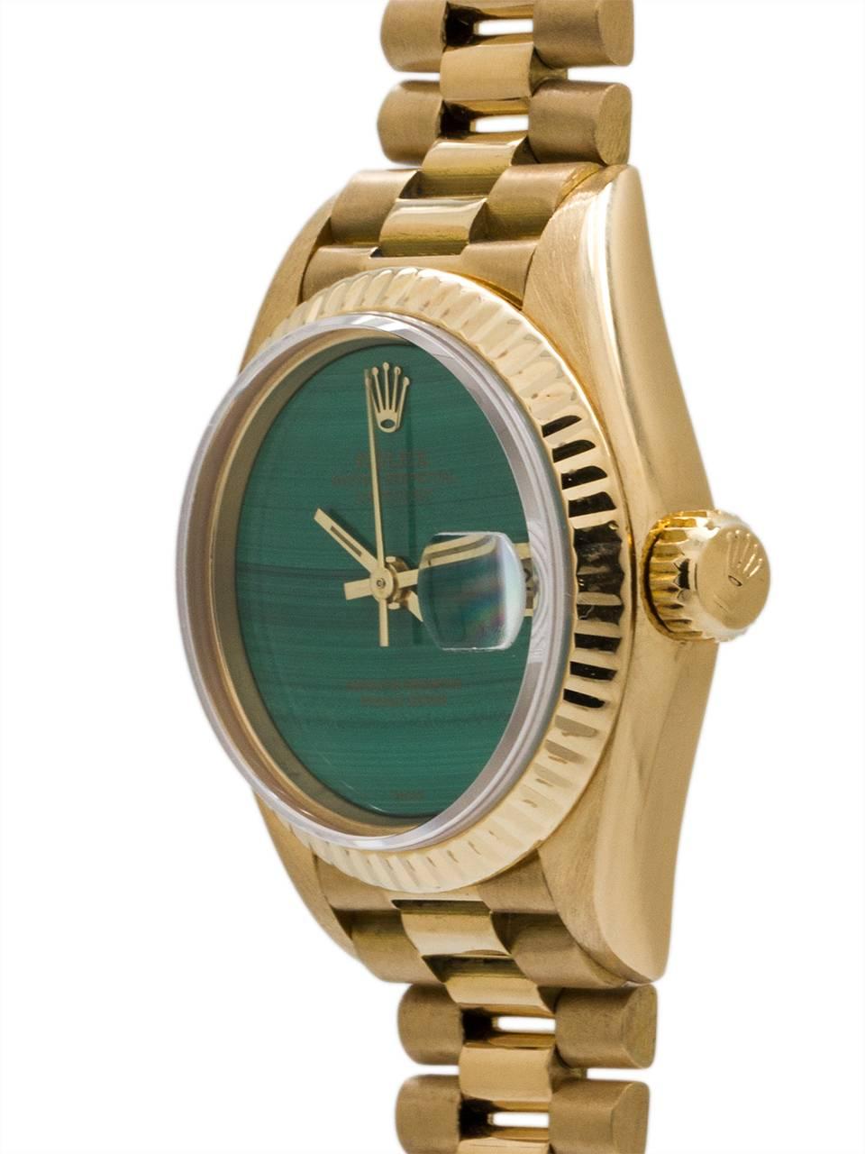 Exceptionally mint condition and stunning Rolex Lady President ref 69178 serial #8.4 million circa 1985. 27 x 33mm 18K yellow gold case with fluted bezel and sapphire crystal. Brilliant malachite stone dial with applied Rolex logo and date window.