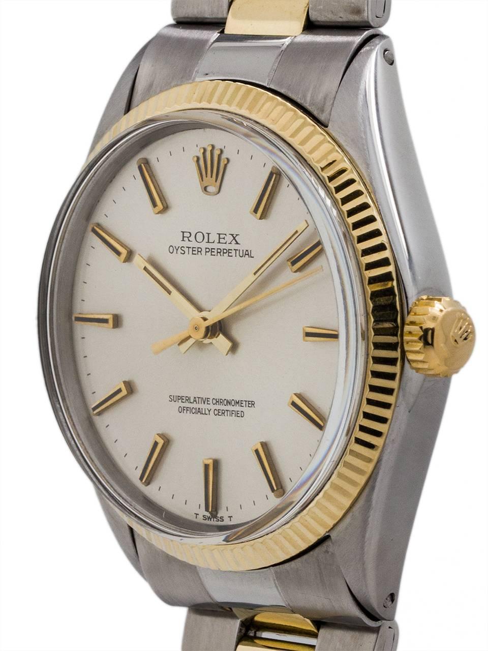 Rolex Stainless Steel and 14K yellow gold Oyster Perpetual ref 1005 serial #2.2 million circa 1969. Featuring 34mm diameter case with fine engine turned “milled” bezel and acrylic crystal. With original silver satin dial with applied gold indexes