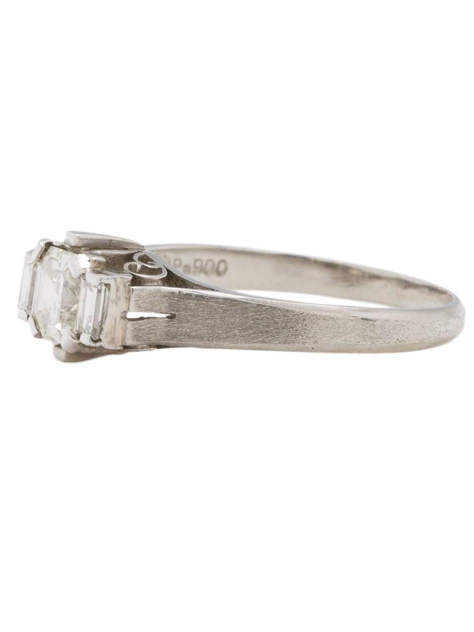 Stunning platinum engagement ring showcasing an EGL certified 0.49 carat Asscher cut diamond, J-SI1. Two perfectly proportioned 0.16 carat matching straight baguette diamond side stones are the perfect accent to the center stone. An elevated and