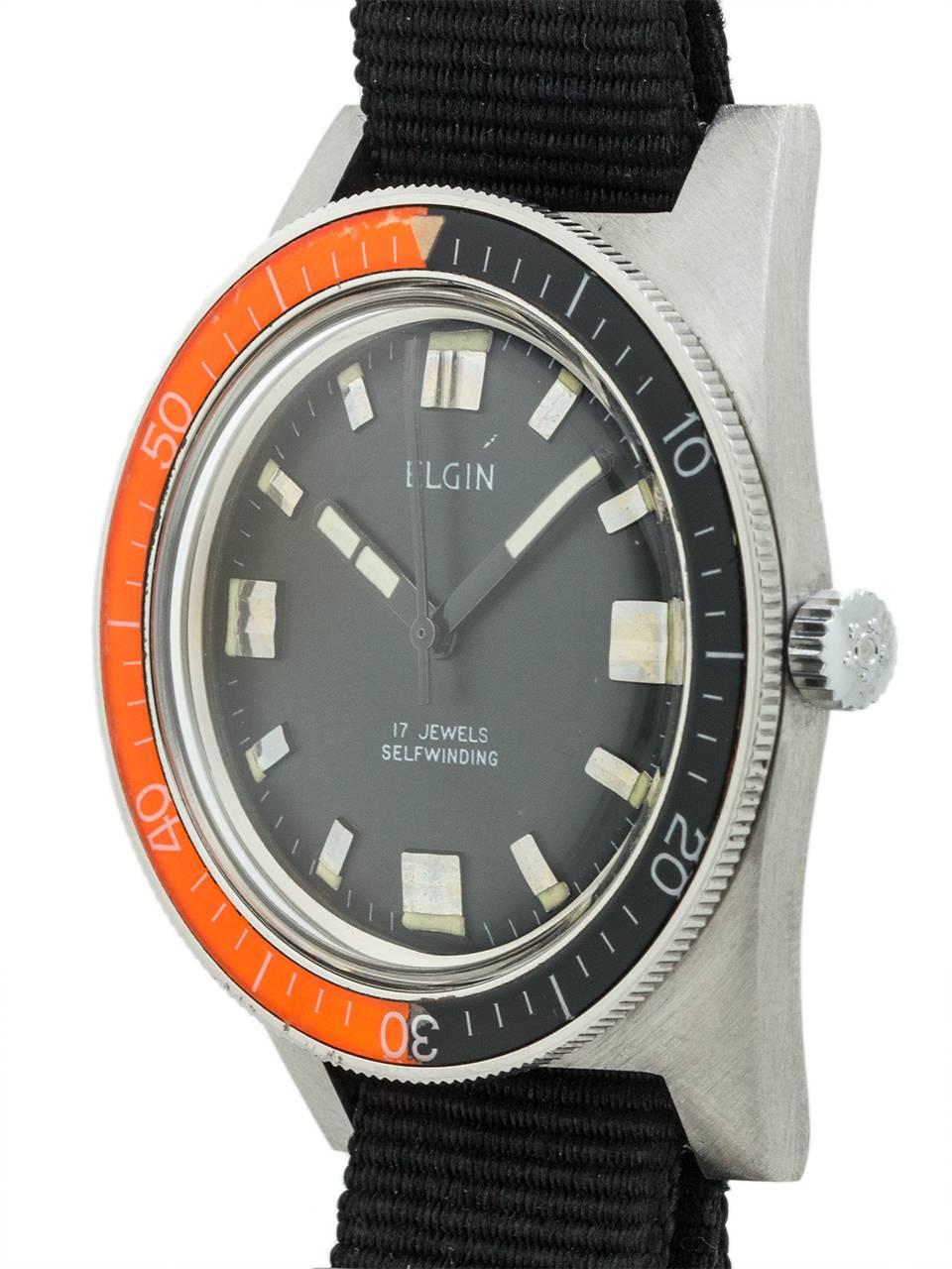 Exceptional condition example vintage Elgin diver’s model ref 4156 circa 1960’s. Featuring 37 x 46mm tonneau shaped case with screw down case back and great looking wide rotating bright reddish/orange and black elapsed time bakelite bezel, acrylic
