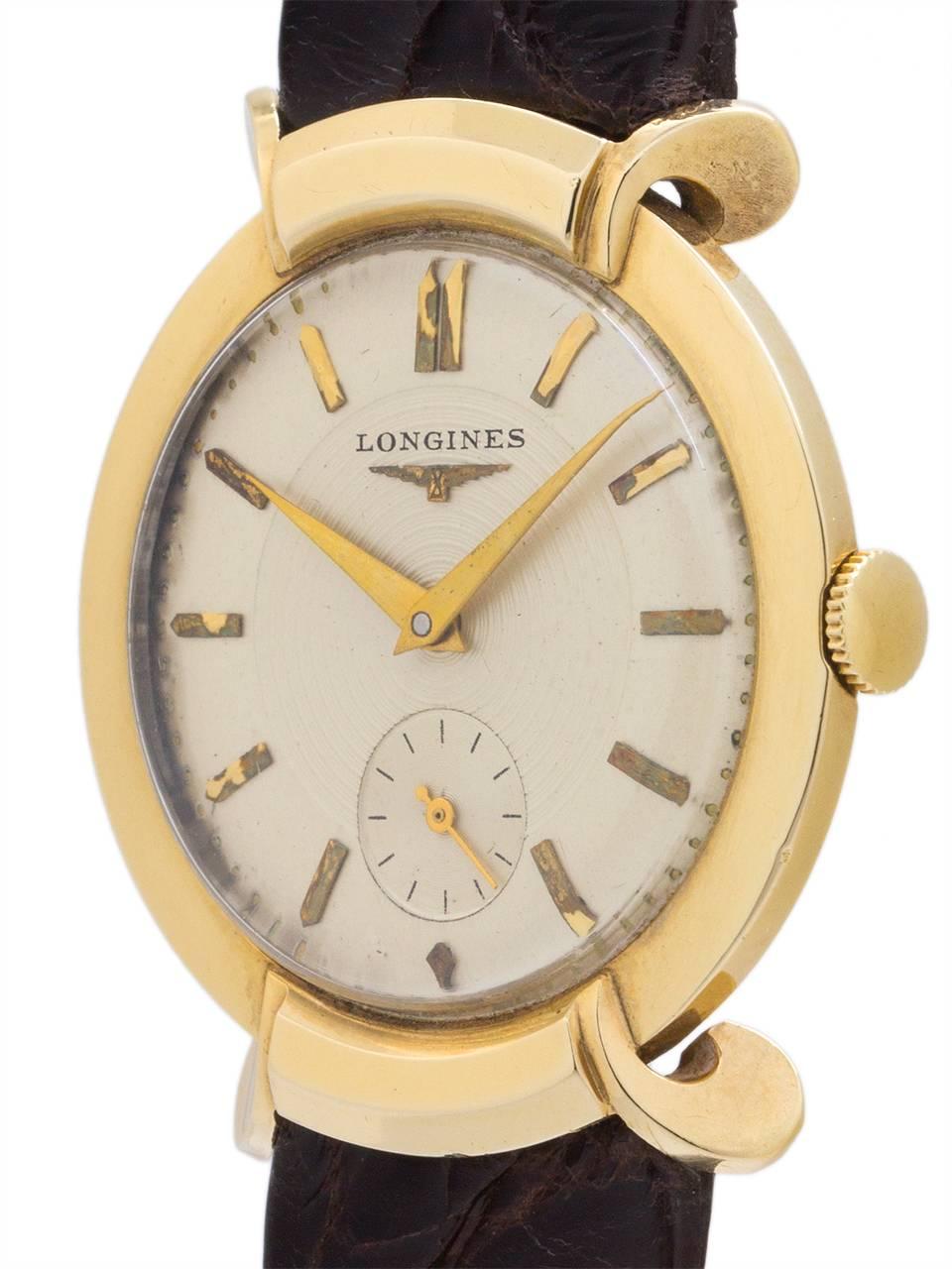 Longines 14K YG dress model so called “turtle” case with extended, beautifully curved lugs. Circa 1950’s. With very pleasing original 2 tone silvered satin dial with gold applied indexes and gold tapered hands. The outside of the dial is a smooth