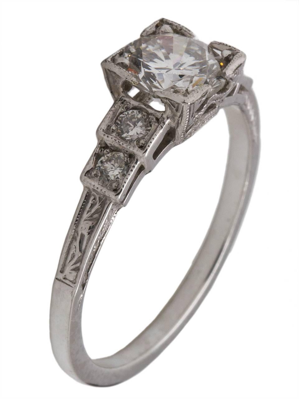 Gorgeous vintage style Art Deco platinum engagement ring reminiscent of the 1930s, featuring an EGL certified 0.85 carat round brilliant cut center diamond, D-SI1. Four bead set round side diamonds set in a stair-step design are the perfect accent