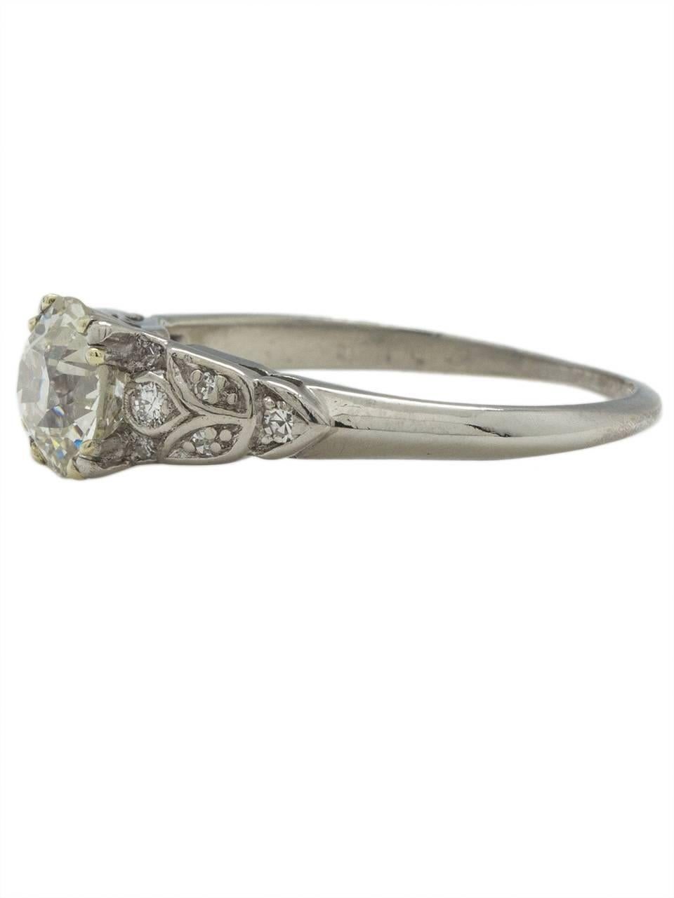 This gorgeous vintage engagement ring from the 1930s features a spectacularly cut EGL certified 1.22ct Old European Cut center diamond, I-VS2. Romantic floral motifs encompass 12 round side diamonds, with a total additional weight of approximately