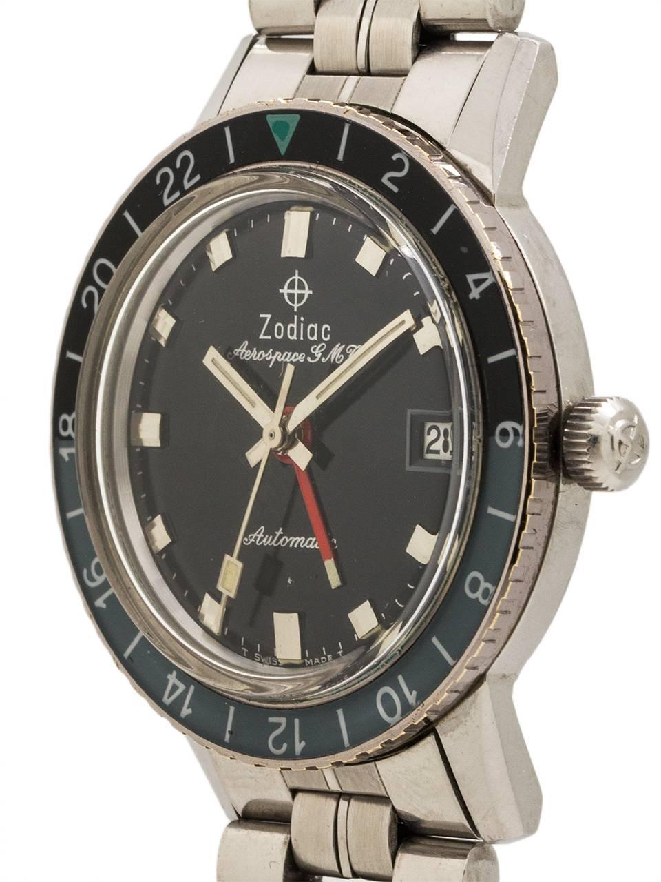 Zodiac Stainless Steel Aerospace GMT automatic circa 1960’s. 36mm case with screw down case back, rotating 24 hour black and gray acrylic bezel with green triangle 24 hour index. Glossy black original dial with luminous hands and red 24 hour hand.