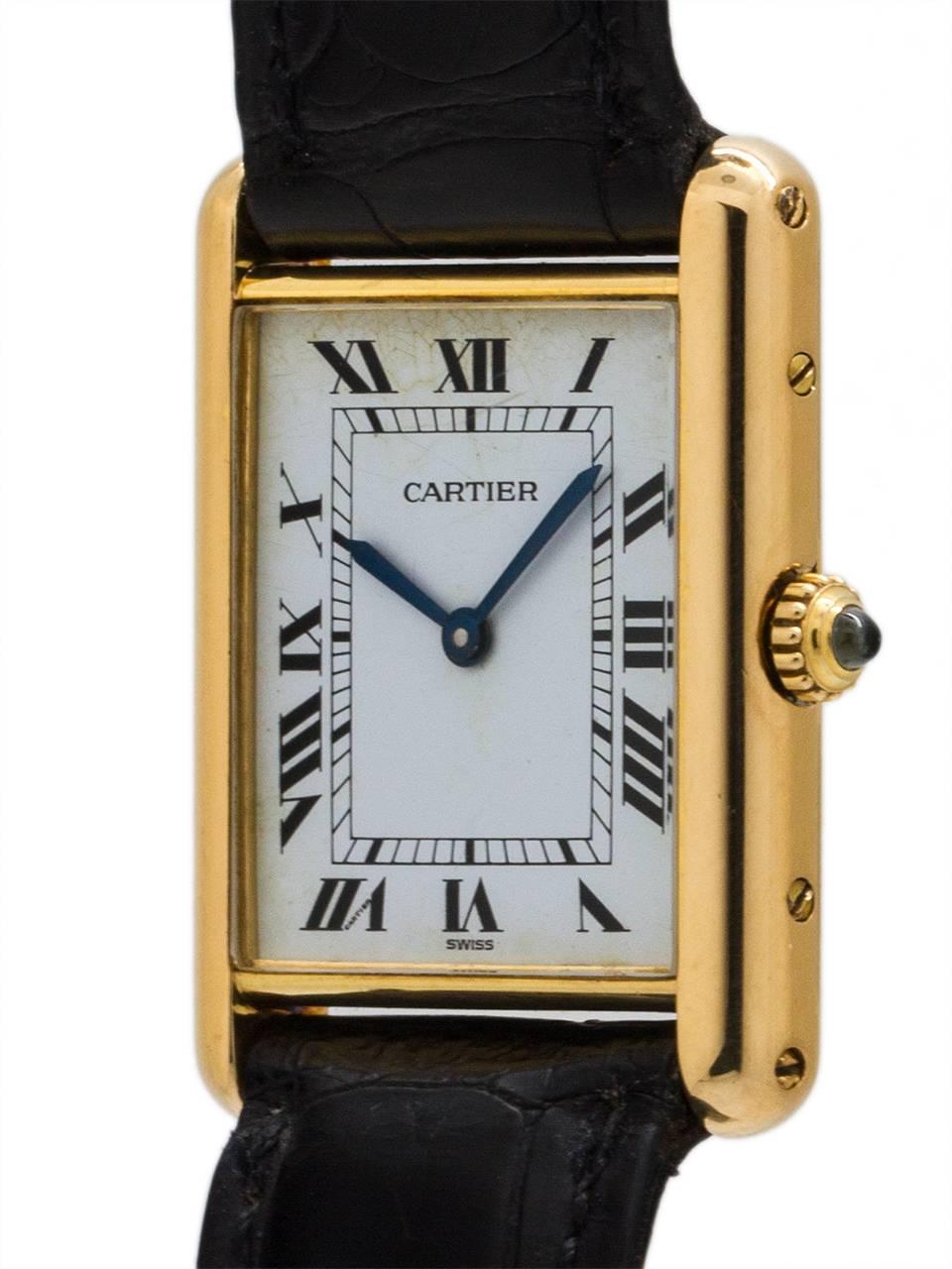 Cartier Man’s Tank Louis 18K YG circa 1990s. Featuring 24 x 30mm 18K yellow gold case secured by 4 side and 4 case back screws. Featuring classic white Cartier dial, signed Must de Cartier with printed black Roman numerals and blued steel hands.