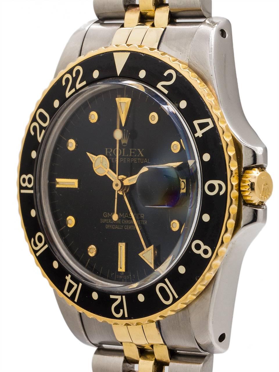 
Rolex SS GMT-Master model ref# 16753 serial # 6.3 million circa 1980. Featuring a 40mm Oyster case with all black, steel and 18k yellow gold 24 hour bezel, and acrylic crystal. With very beautiful condition matte black dial with richly patina’d