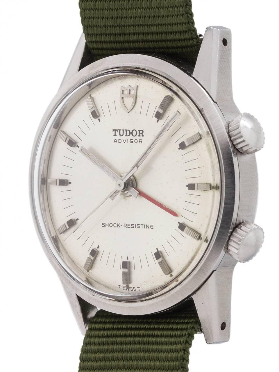 
Man’s vintage Tudor Advisor alarm model ref #10050 circa 1982. Featuriing a 34 x 41mm stainless steel screw back case with silver satin original dial signed Tudor Advisor Shock Resisting T SWISS T, with with applied silvered indexes with patina’d