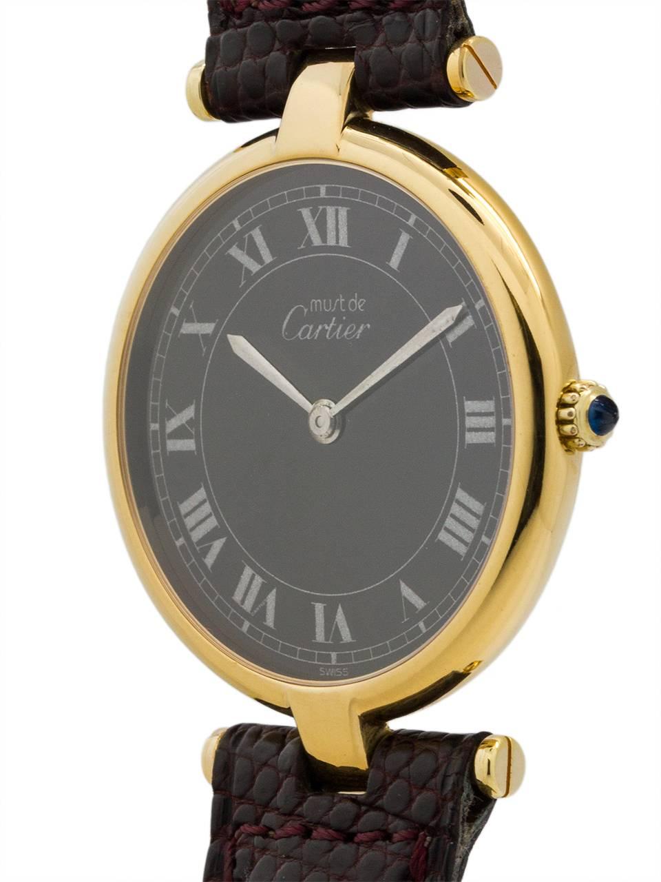 Cartier Man’s Vermeil Vendome Tank Wristwatch circa 1990s. Case measuring 30.5 x 37mm and t-bar lugs. Featuring a rare original black dial with printed Roman numbers and outer minute track. Quartz movement with cabochon sapphire crown. With reddish